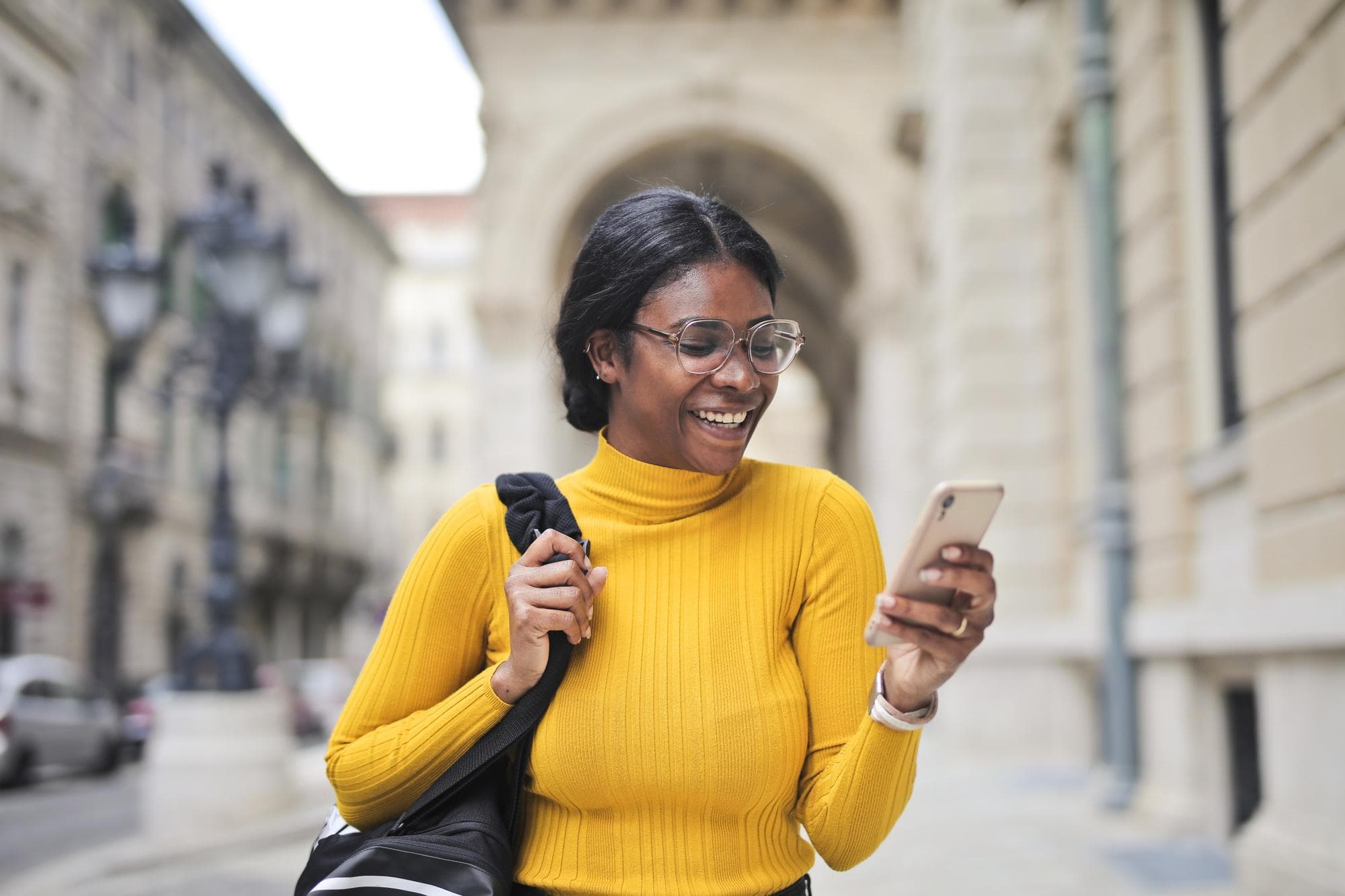 Traveller using her phone on a city street